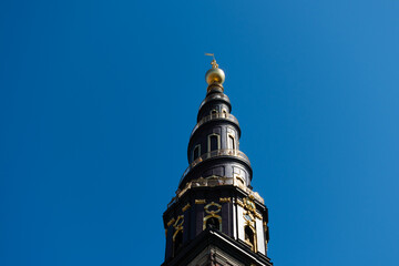 Spiral top of the tower of Church of Our Saviour in Copenhagen, Denmark against the blue sky in summer