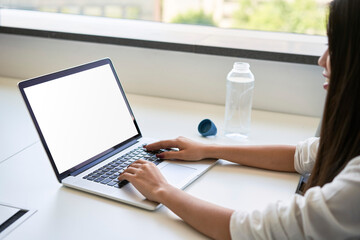 Laptop mockup. Young Asian woman typing on laptop with blank screen