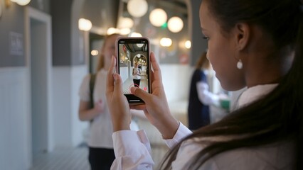 interracial couple or friends recording trendy dance moves for social media account in high school