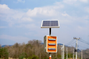 Mini solar cell panel installed outdoor. Blue sky background. Concept : using green and clean energy for environment.  Renewable energy, Natural power from sunlight to reduce global warming.         
