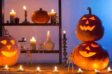 halloween pumpkins with candles on wooden table