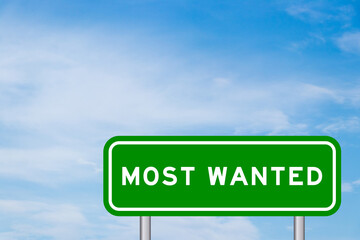 Green color transportation sign with word most wanted on blue sky with white cloud background © bankrx