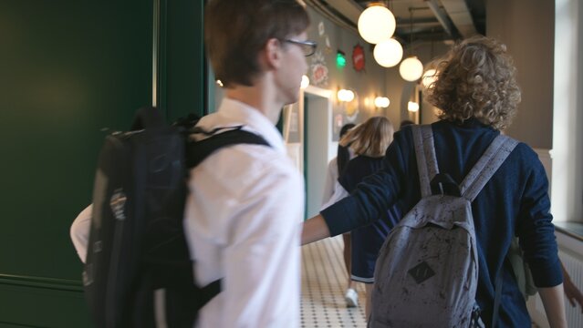 Teen students leave classroom after lesson and go on a break