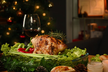 Homemade roasted turkey or chicken at festive Christmas or Thanksgiving table with all the sides