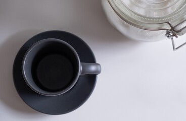 cup of coffee in the morning and sugar bowl background. horizontal image from above, overhead

