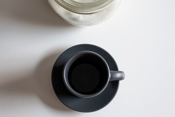 cup of coffee in the morning and sugar bowl background. horizontal image from above, overhead
