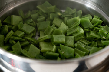 green bean in pot In the act of boiling. closeup image. landscape picture.
