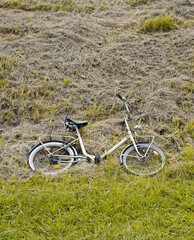 Old-fashioned bicycle lying on ground.