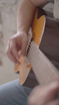 close-up rhythmically plays the acoustic guitar
