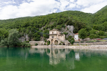 Fototapeta na wymiar Scanno lake in Abruzzo in Italy in summer with the Church of the Madonna del Lago in the background.