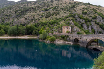 Fototapeta na wymiar Lake of San Domenico in Abruzzo, Italy and the Eremo di San Domenico in the background.