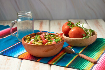 Traditional mexican nopal cactus salad or nopales a la mexicana. Vegan food.