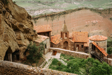 View of David Gareja Lavra orthodox monastery caves built in rock Georgia in semi-desert.  - 529466731