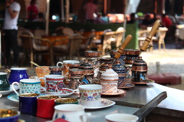 selective focus : turkish coffee cups, turkish coffee cups and coffee pots decorated with local patterns, each more colorful than the other, lined up on the coffee counter in kozahan bursa turkey