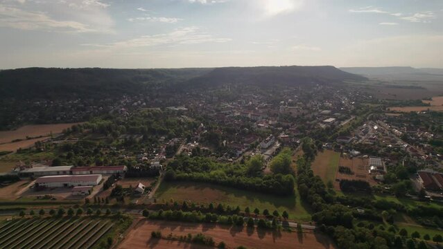Aer ial view of a German village surrounded by meadows, farmland and forest in Germany.