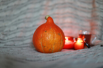 Pumpkin and candles, tea and a plaid in the background