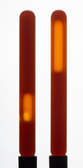 Yellow viscous liquid sunflower lecithin with bubbles in a transparent test tube on a white background