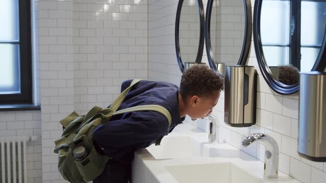 African-American teen student suffer from stomach ache having food poisoning