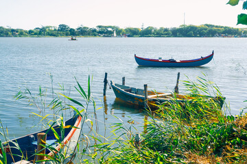 Obraz premium Fishing boats on the evening lake. Summer landscape in a natural park