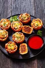 sloppy joe cups on black plate, top view