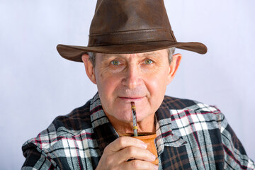 Attractive old man and rural style drinking the typical infusion in Argentina called Mate