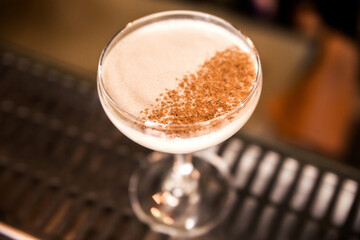 Close-up of a white colored cocktail garnished with cinnamon