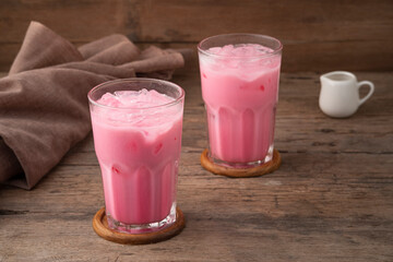 Thai style iced pink milk.Cold sweet drink Red Grenadien Sugar Syrup mix with milk and iced cube in...
