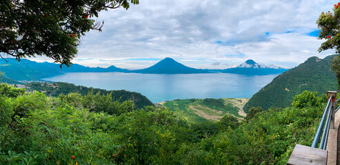 Lake Atitlan Guatemala Panoramic Shot With Lush Green Jungle Rainforest Foliage And Guatemalan...