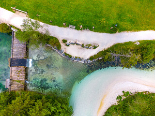 Schiederweiher in Hinterstoder top bottom drone aerial view to small dam and flowing water