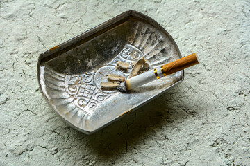 Squeezed remnants of cigarettes in an ashtray