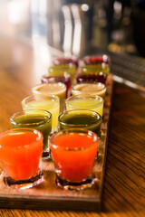 Colourful set of alcoholic cocktails in shot glasses shooters for an alcoholic party. Set of different colorful natural fruit alcoholic tinctures.