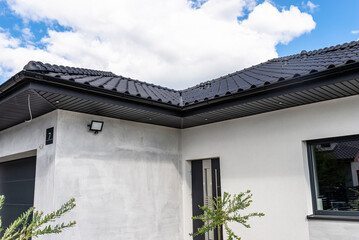 A modern graphite herringbone roof lining is attached to the trusses, visible turned on LED lights.