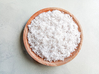 Grated coconut in wooden plate on white background. Grated coconut. 