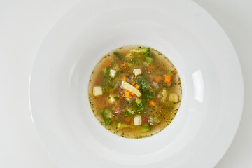 soup with vegetables, mushrooms and slices of cheese