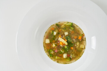 soup with vegetables, mushrooms and slices of cheese