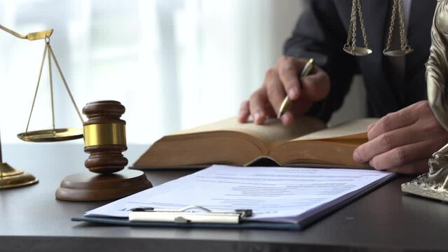 Close up lawyer man reading law book in office workplace for consultant lawyer concept.