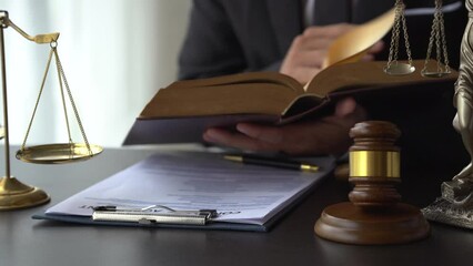 Close up lawyer man reading law book in office workplace for consultant lawyer concept.