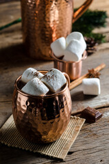 The dessert food vintage style : The Marshmallow with hot chocolate in copper cup on the wooden table. Background copy space for copy text