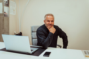 A businessman sits in his and works with paperwork. High quality photo