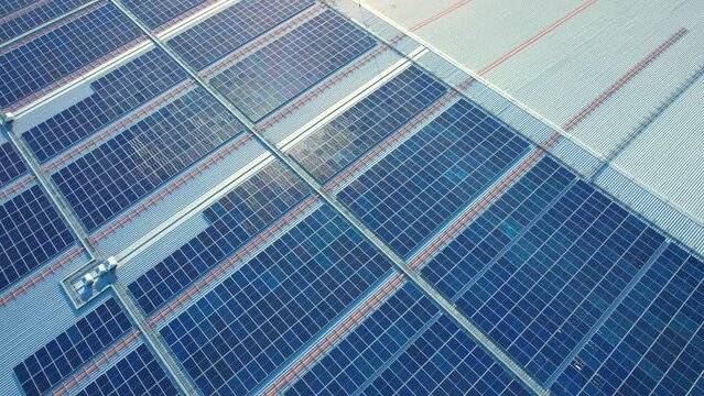 Top view of a solar power station on building roof, Renewable green energy. Clean energy industry. drone footage. 4k
