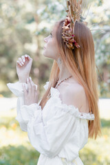 Obraz premium Bride of the sun in white in the apple trees