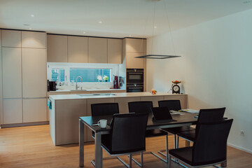 Modern white kitchen with electronic devices and decorative items
