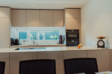 Modern white kitchen with electronic devices and decorative items
