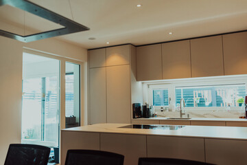 Modern white kitchen with electronic devices and decorative items