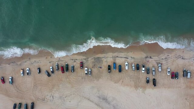 Aerial View Top Down of Vehicles and People Fishing on the Beach a Cape Point in the Outer Banks North Carolina