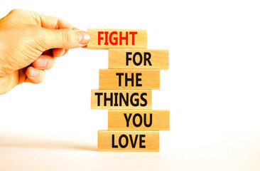 Fight for love symbol. Concept words Fight for the things you love on wooden blocks on a beautiful white table white background. Businessman hand. Business motivational and fight for love concept.