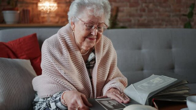Senior woman looking at photographs in album