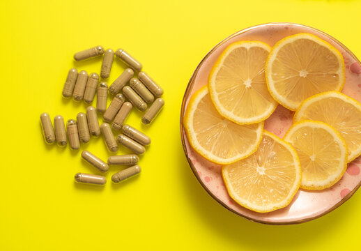 kratom pills composition on yellow background with lemon slices
