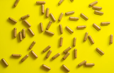 kratom pills random composition on yellow background