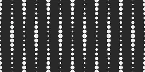 Obraz premium White circles in a row vertically. Dotted line design made up of dots on a black background.